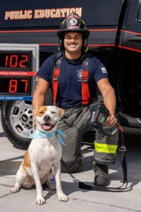 Poppy shows off the new Gulf Coast Humane Society Fireman’s Calendar