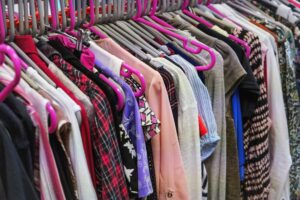 Clothing on hangers at a thrift shop