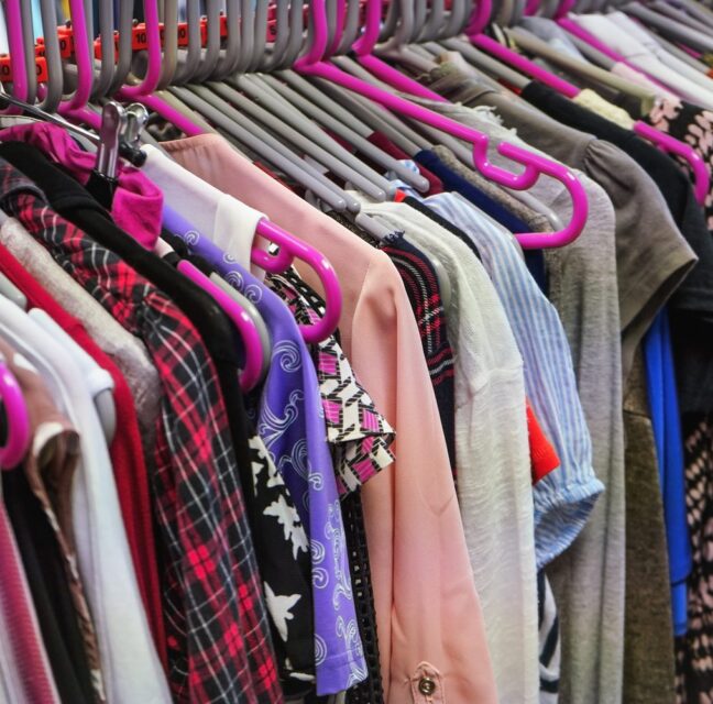 Clothing on hangers at a thrift shop