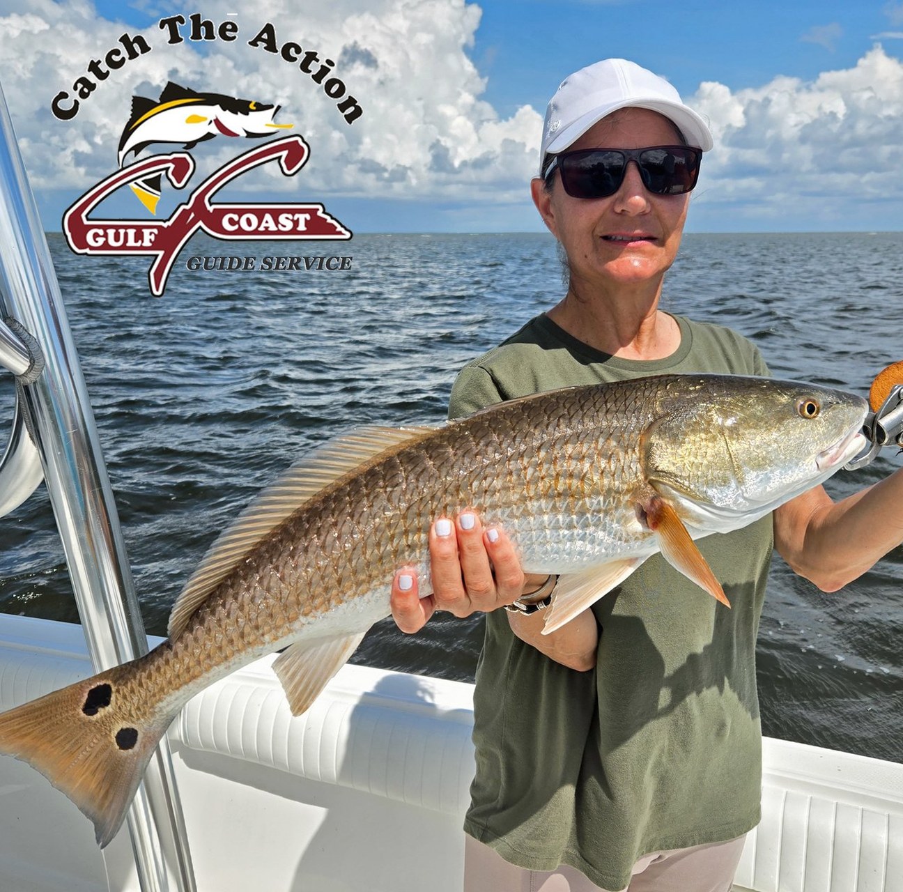 Angler on a boat holding a redfish caught in Gulf Coast waters