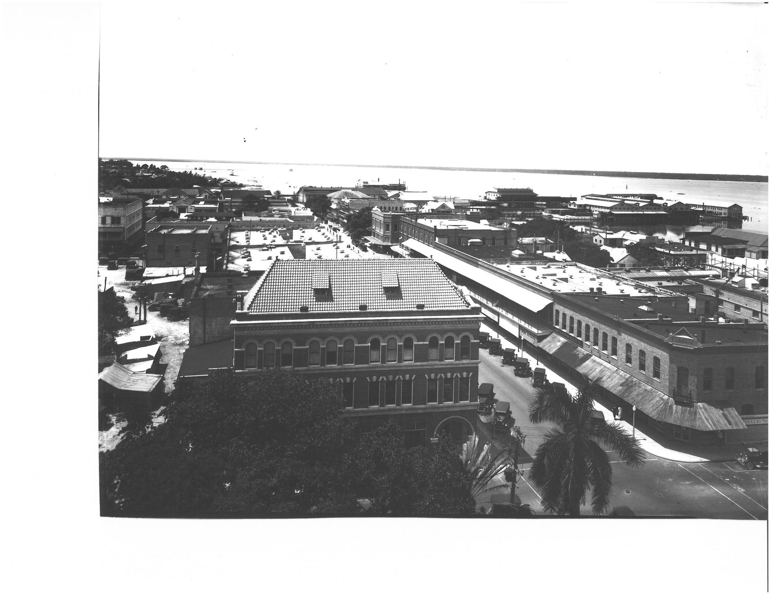Elevated view over a downtown Fort Myers block toward the riverfront