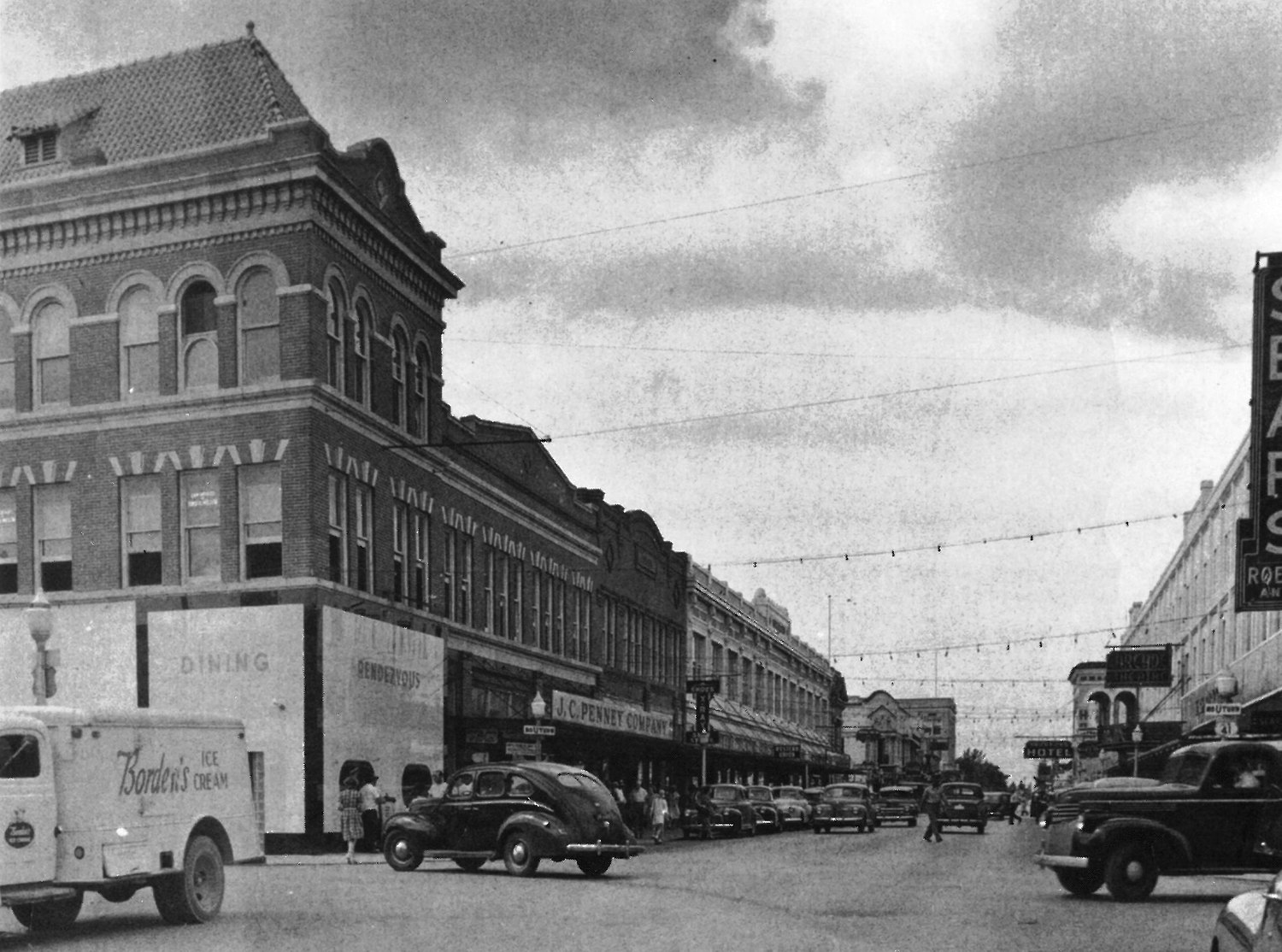First Street business district with period storefronts and automobiles