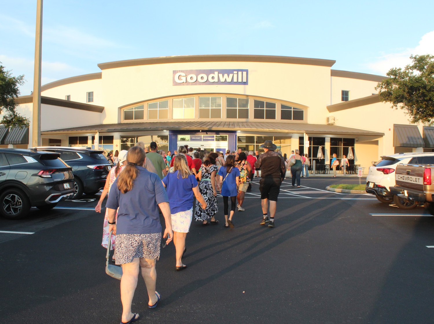 Shoppers crossing the parking lot toward the new Goodwill Punta Gorda store
