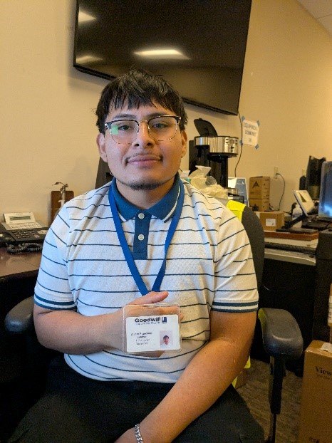 Alvaro wearing his Goodwill badge after completing the Opportunity Accelerator program