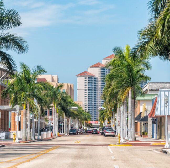 A palm-lined street in downtown Fort Myers on a sunny day