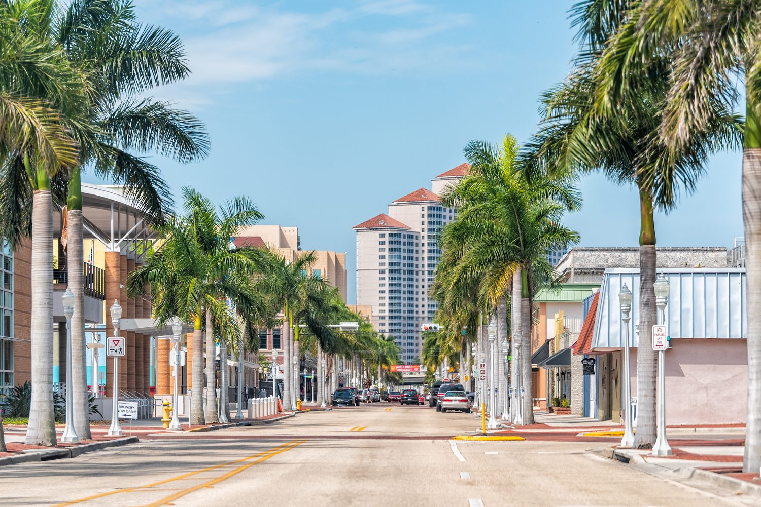 A palm-lined street in downtown Fort Myers on a sunny day
