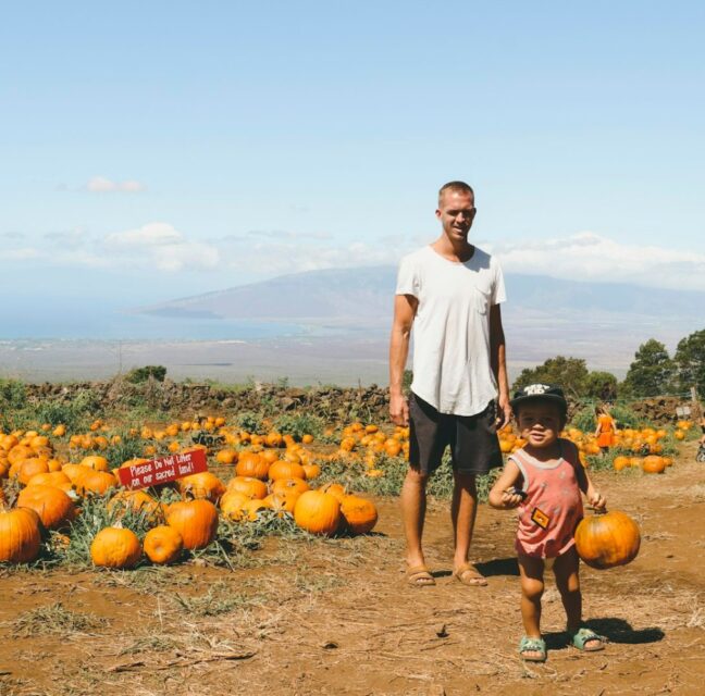 A parent and child at a pumpkin patch. Photo: Derek Owens / Unsplash